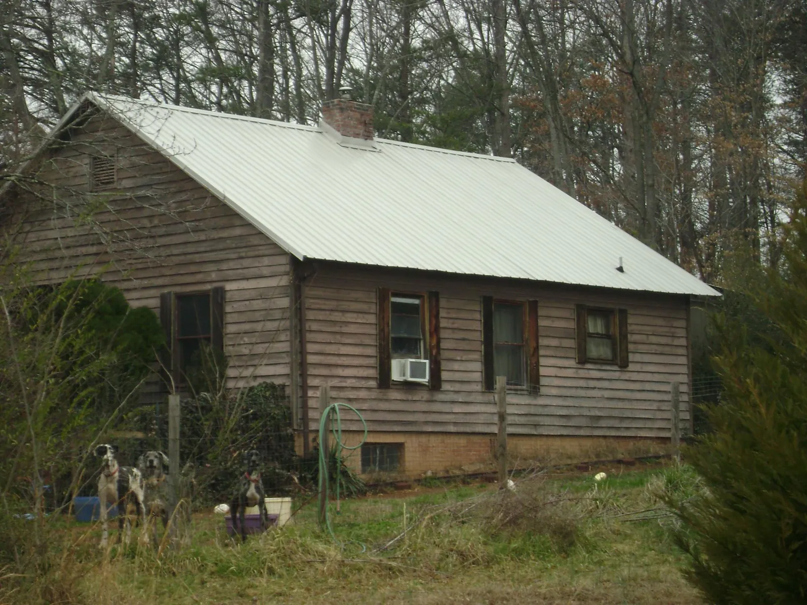 White metal roof on an old wood sided farmhouse, from a Metal Roof Installation job in Portland
